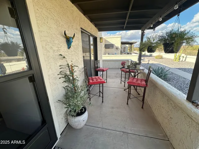 a balcony with furniture and a potted plant