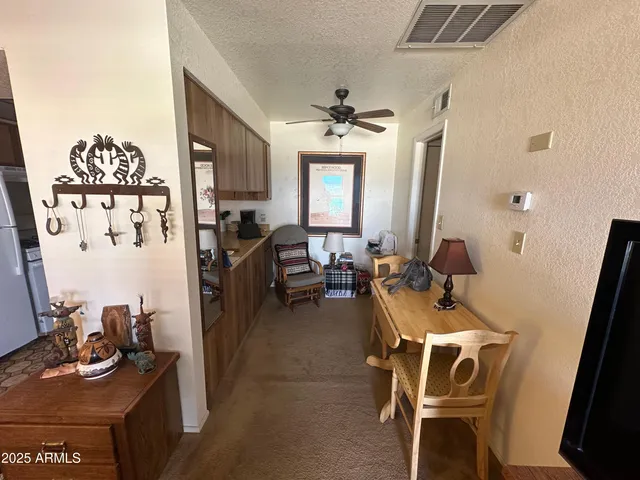 a room with furniture a rug and white walls