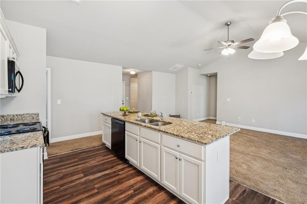 224 Katie Lane Commerce, GA 30529 - Photo 11 of 35 a kitchen with a stove a sink and a refrigerator