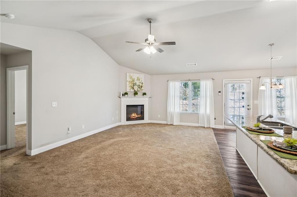 224 Katie Lane Commerce, GA 30529 - Photo 17 of 35 an empty room with windows and fireplace