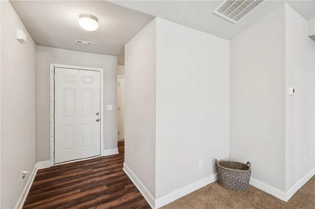 a view of a room with wooden floor and closet