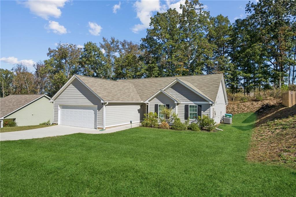 224 Katie Lane Commerce, GA 30529 - Photo 3 of 35 a view of a house with a big yard and large trees