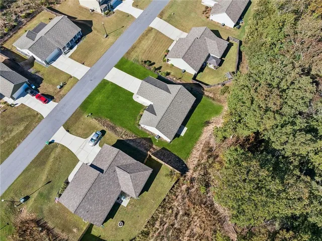 an aerial view of a house with a yard