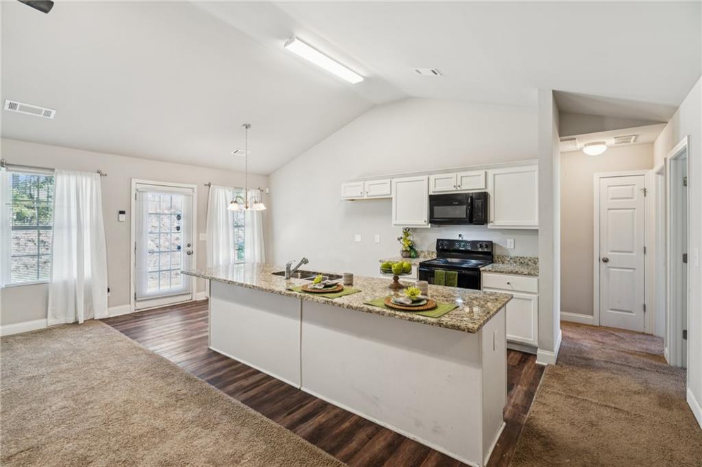 224 Katie Lane Commerce, GA 30529 - Photo 9 of 35 a kitchen with a sink stove and refrigerator