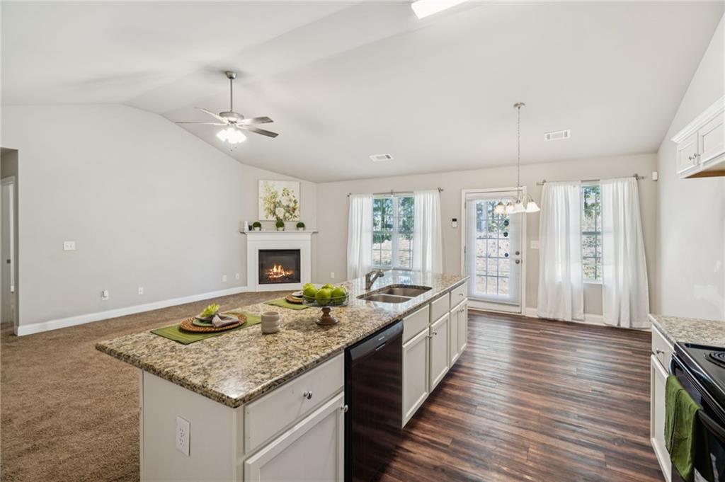 224 Katie Lane Commerce, GA 30529 - Photo 10 of 35 a spacious bathroom with a granite countertop sink and a wooden floor