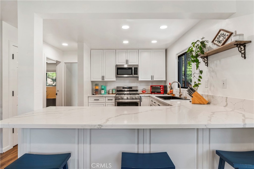 899 Blue Ridge Drive Lake Arrowhead, CA 92385 - Photo 8 of 49 a kitchen with sink cabinets and appliances