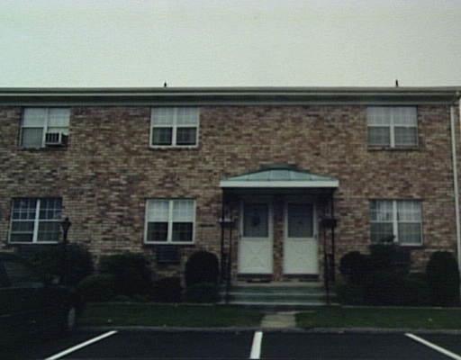 an front view of a house with a yard