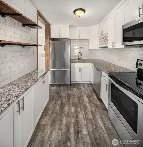a kitchen with a sink appliances and cabinets