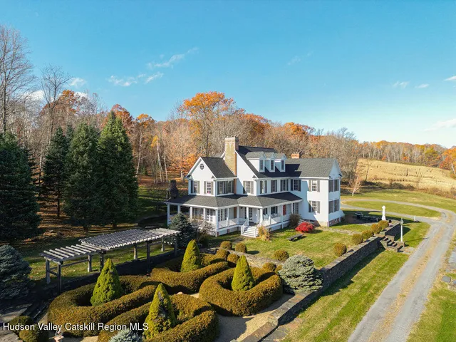 a view of a house with swimming pool and sitting area