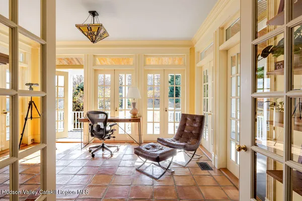 a living room with furniture and floor to ceiling windows