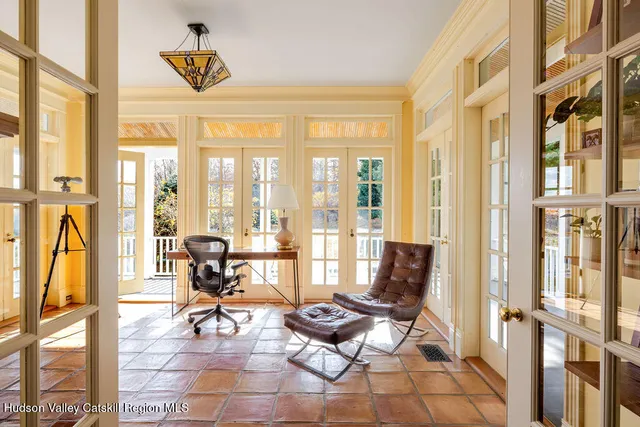 a living room with furniture and floor to ceiling windows