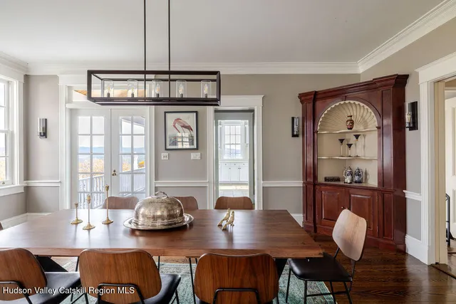 a view of a dining room with furniture wooden floor and chandelier