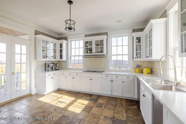 a large kitchen with stainless steel appliances granite countertop a window and a sink