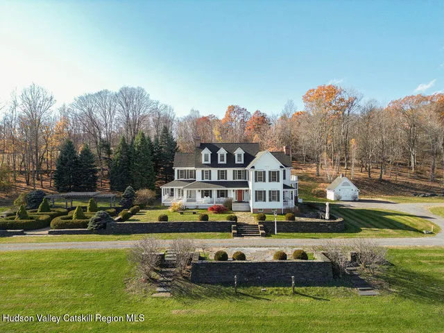 a view of a house with swimming pool and a yard