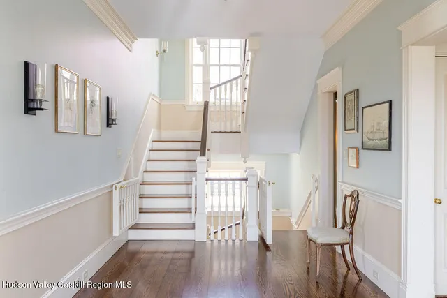 a view of entryway and hall with wooden floor