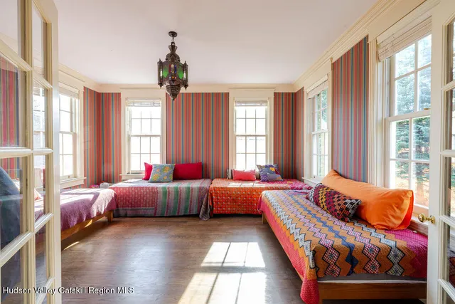 a bedroom with bed and windows