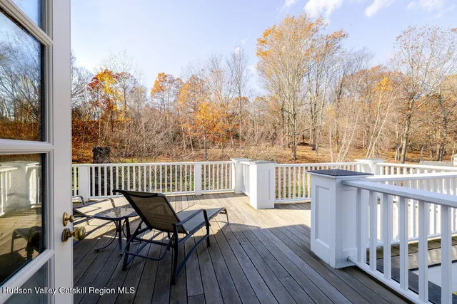 a view of a chair and table on the deck