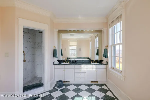 a bathroom with a sink a mirror and a shower
