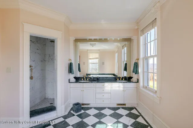 a bathroom with a sink a mirror and a shower