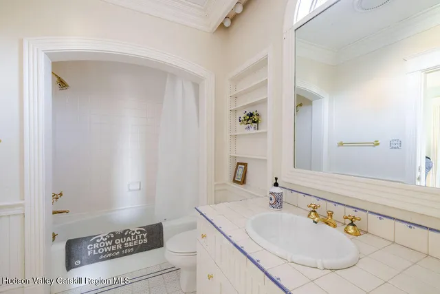 a bathroom with a sink a vanity and a mirror