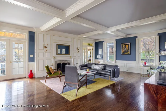 a living room with fireplace furniture and a wooden floor