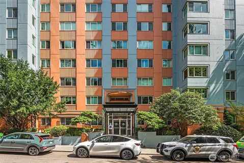 a front view of a residential apartment building with a street