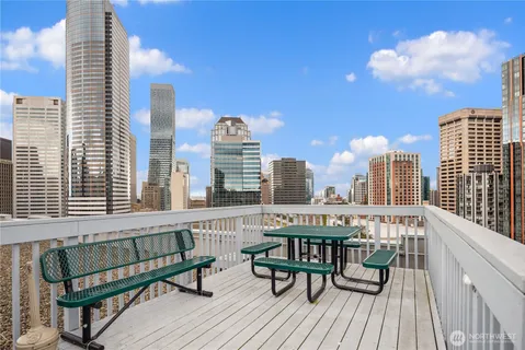 a view of a balcony with wooden floor and outdoor seating