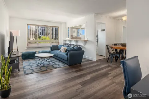 a living room with furniture a dining table and a window