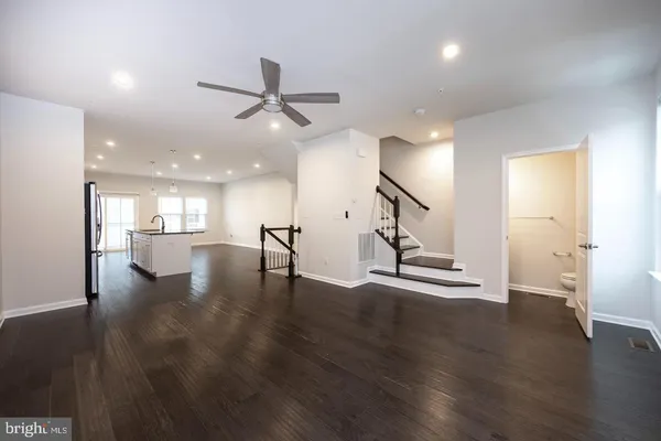 a view of an empty room and wooden floor