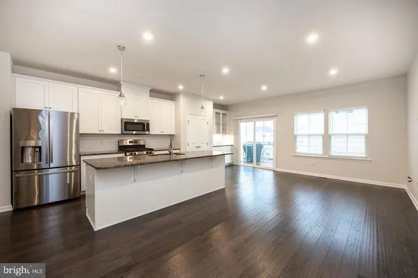 a kitchen with stainless steel appliances a refrigerator a sink and a stove top oven