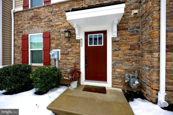 a view of a brick house with potted plants