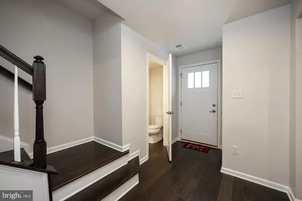 a view of an empty room and wooden floor