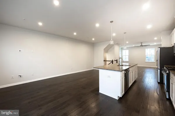 a view of kitchen with sink and wooden floor