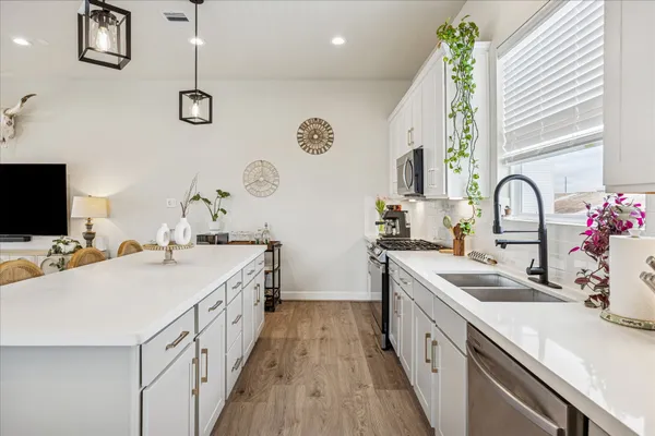 a kitchen with a sink and a stove top oven