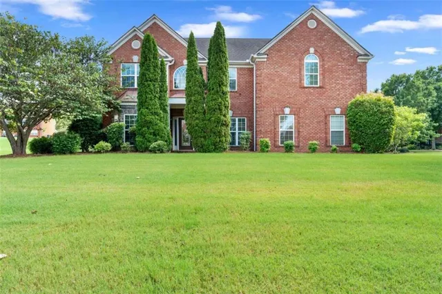 a front view of a house with a yard