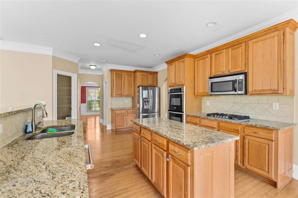 4201 Donington Way Hampton, GA 30228 - Photo 15 of 43 a kitchen with stainless steel appliances granite countertop a stove a sink and a microwave