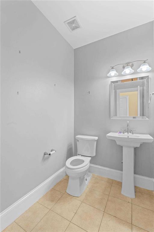 4201 Donington Way Hampton, GA 30228 - Photo 20 of 43 a bathroom with a sink a toilet and mirror