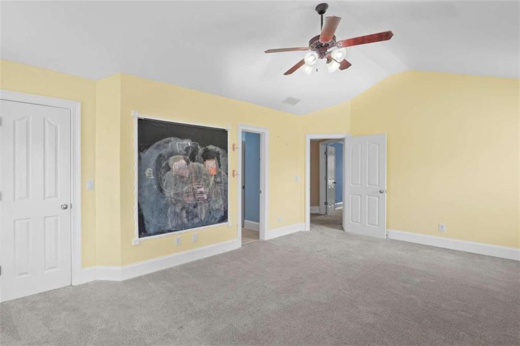 4201 Donington Way Hampton, GA 30228 - Photo 28 of 43 a view of an empty room with a ceiling fan