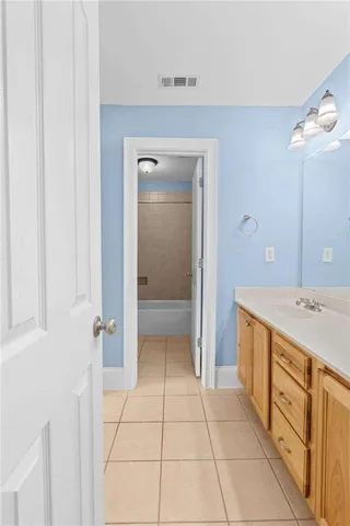 a view of an empty room with a ceiling fan