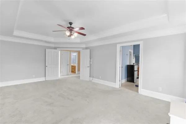 a bathroom with a tub a sink and a large mirror
