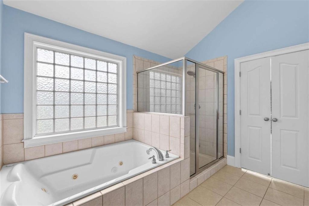 4201 Donington Way Hampton, GA 30228 - Photo 36 of 43 a bathroom with a tub a window and a shower