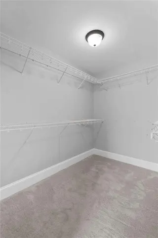 an aerial view of a house with a yard and trees