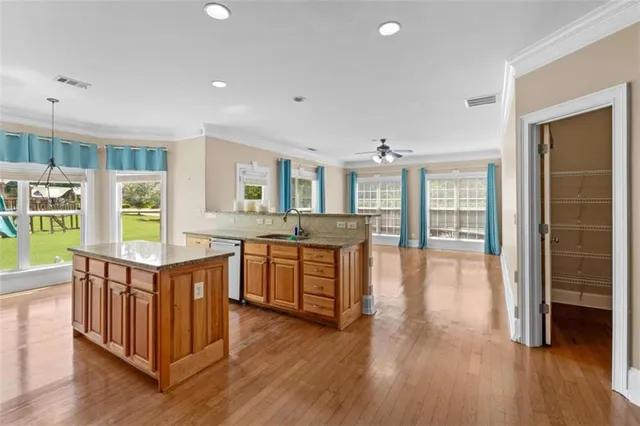 a open kitchen with stainless steel appliances granite countertop a lot of counter space and wooden floors