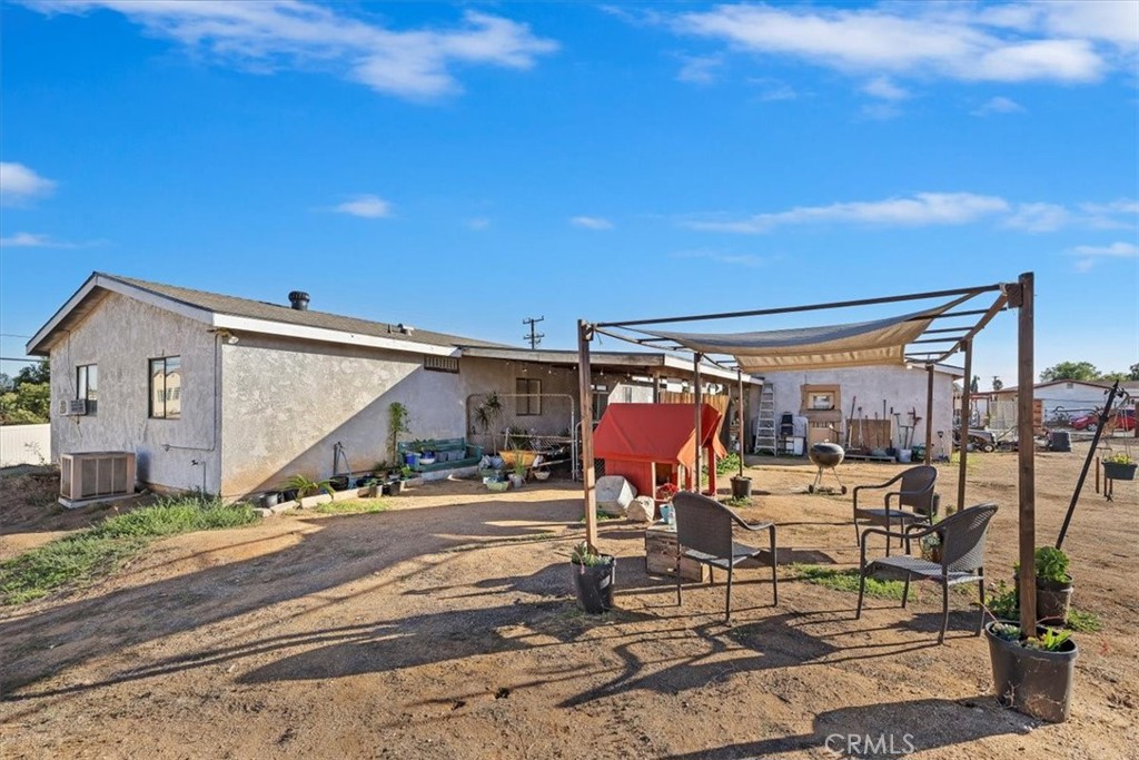 16915 Wood Road Riverside, CA 92508 - Photo 17 of 43 a view of a patio with table and chairs