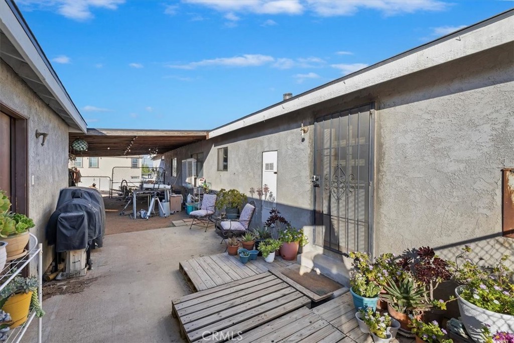 16915 Wood Road Riverside, CA 92508 - Photo 21 of 43 a view of a patio with table and chairs and potted plants
