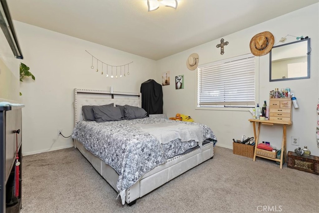 16915 Wood Road Riverside, CA 92508 - Photo 40 of 43 a bedroom with a bed and a table in it
