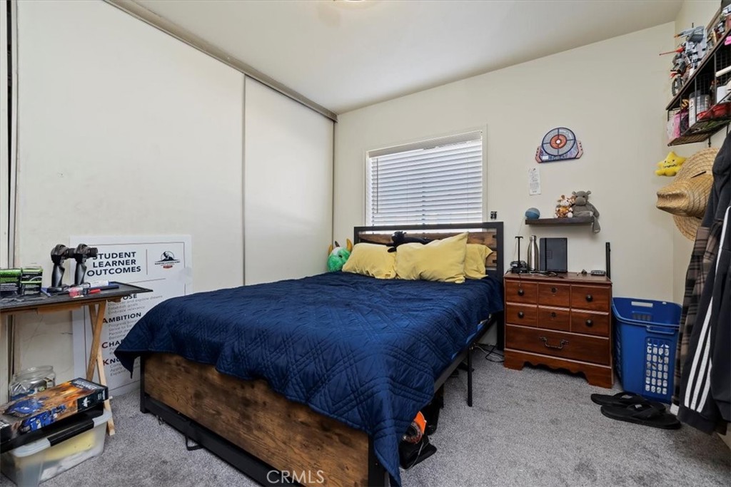 16915 Wood Road Riverside, CA 92508 - Photo 42 of 43 a bedroom with a bed and a tv in it