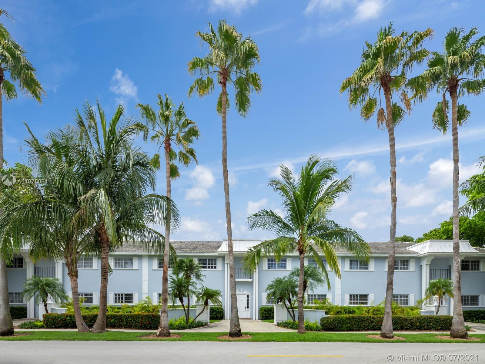 a view of multiple houses with palm trees