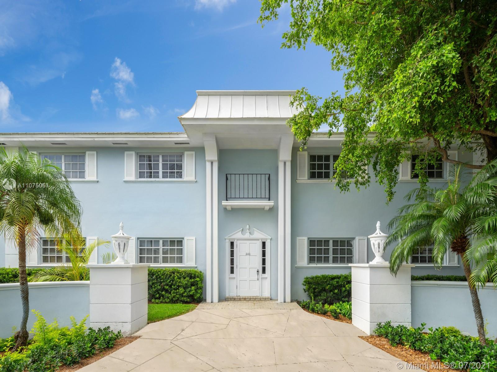 202 Sunrise Drive Key Biscayne, FL 33149 - Photo 4 of 12 a front view of a house with a garden