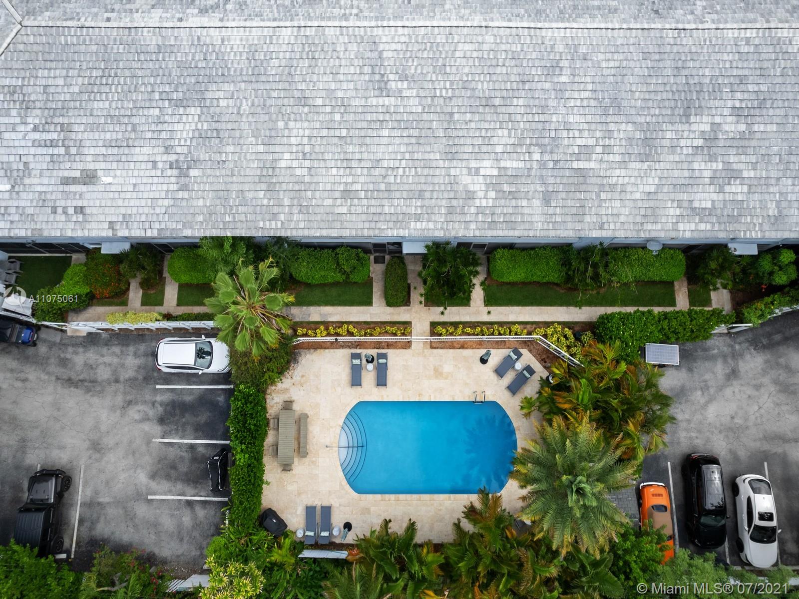 202 Sunrise Drive Key Biscayne, FL 33149 - Photo 7 of 12 a view of a backyard with plants and outdoor seating